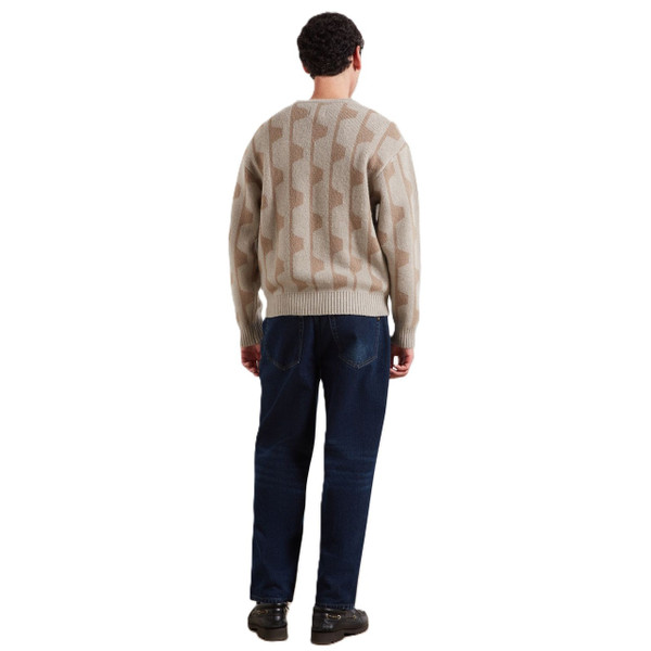 Model Wearing Farah Glynn Men's Relaxed V-Neck Geo Jacquard Jumper in Putty - Back facing full length