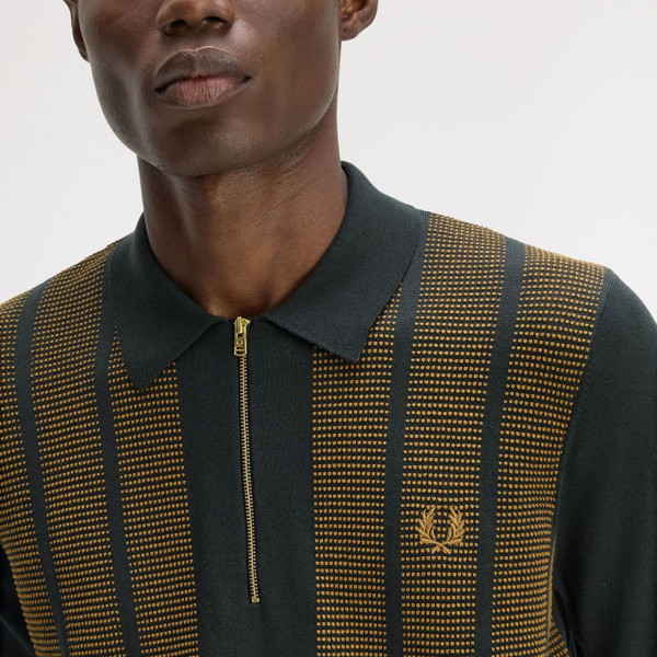 Model Wearing Fred Perry Textured Panel Knitted Zip Neck Polo Shirt in Night Green - Close up laurel wreath