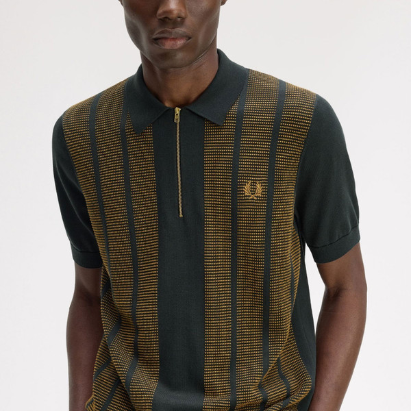 Man wears Fred Perry Textured Panel Knitted Zip Neck Polo Shirt in Night Green