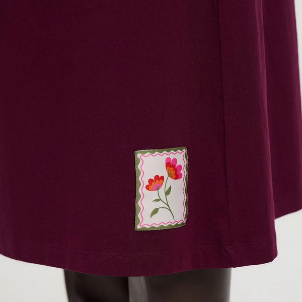 Flower patch on hem of Sugarhill Brighton Abella Flower Patch Jersey Midi Dress in Wine