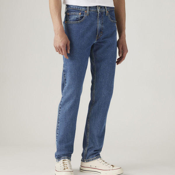 Model Wearing Levi's 502 Taper Men's Blue Denim Jeans in Stonewash Stretch - Front facing from angle