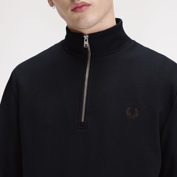Model Wearing Fred Perry Half Zip Funnel Neck Sweatshirt in Navy / Brandy / Rich Brown - Close up chest zipped up
