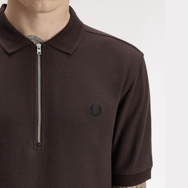 Model wearing Fred Perry Crepe Pique Polo Shirt in Rich Brown - Front facing close up