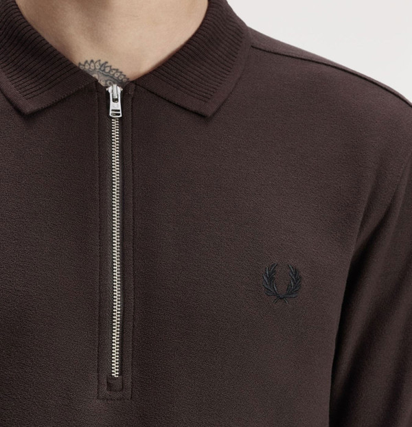 Model wearing Fred Perry Crepe Pique Polo Shirt in Rich Brown - Front facing close up