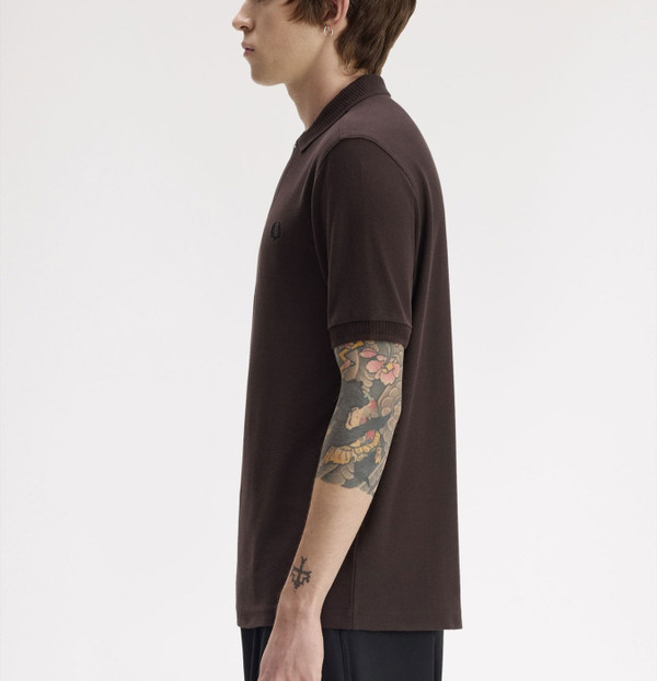 Model wearing Fred Perry Crepe Pique Polo Shirt in Rich Brown - Side on