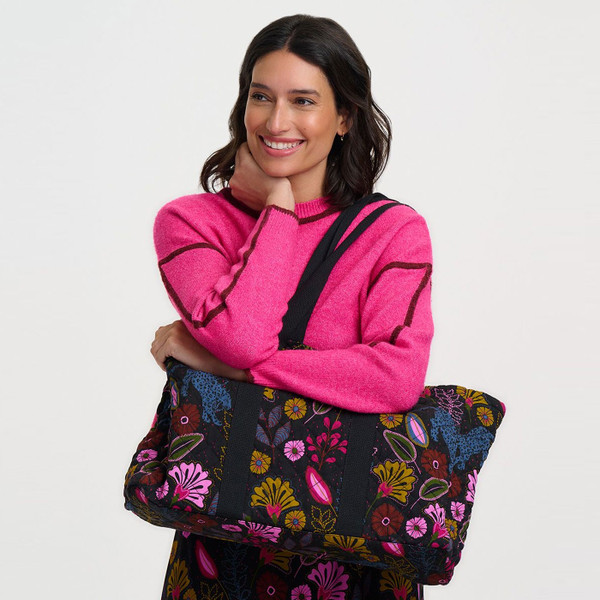 Woman carrying Sugarhill Brighton Haven Jungle Panther Quilted Tote Bag in Black