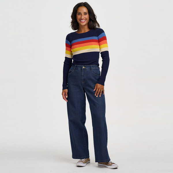 Woman wearing Sugarhill Brighton Cayla Rainbow Stripes Ribbed Jumper in Navy