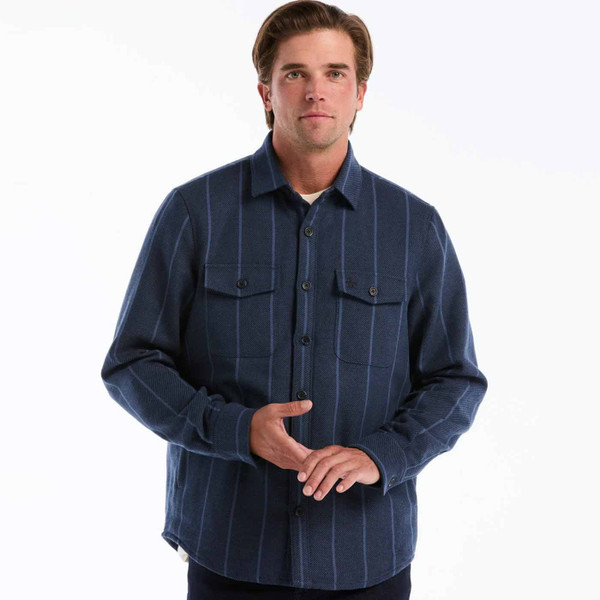 Man wearing Original Penguin Men's Striped Twill Overshirt in Dark Sapphire