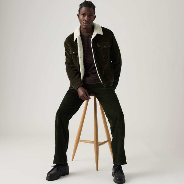 Model Wearing the Levi's Type III Corduroy Sherpa Trucker Jacket Rosin - Sitting Down