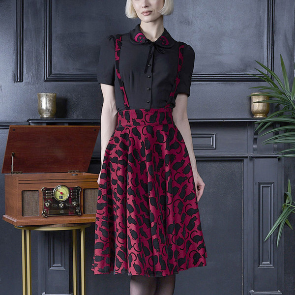 Woman wearing Banned Retro Cecilia Cattitude Black Cat Print Flared Suspender Skirt in Red/Black
