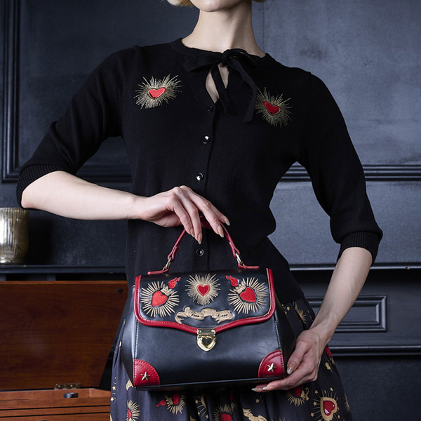 Woman holding Banned Retro True Love Vintage 50s Style Handbag in Black