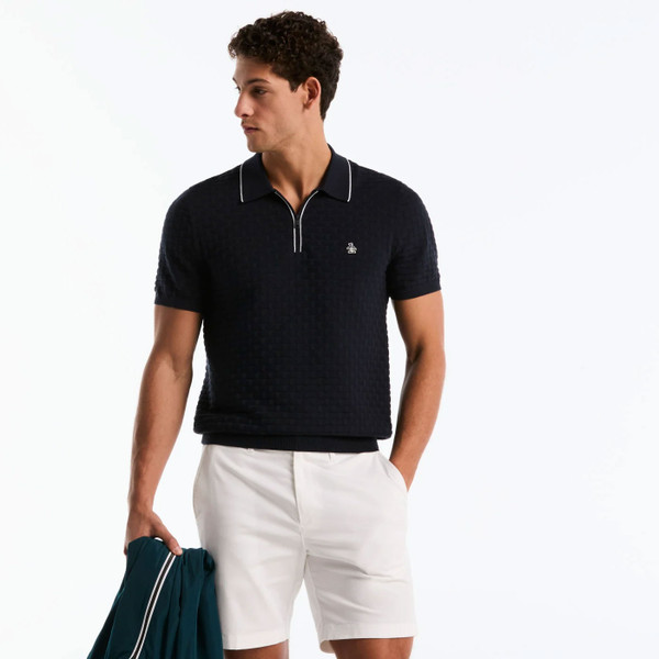 Man wearing Original Penguin Links Stitch Quarter Zip Knitted Polo in Dark Sapphire Navy