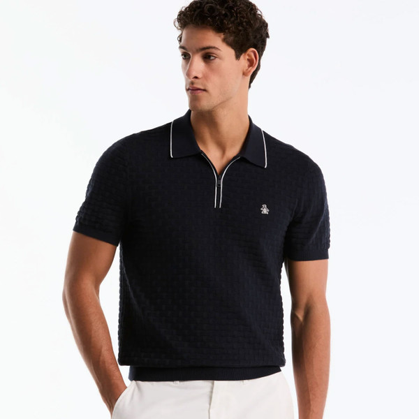 Man wearing Original Penguin Links Stitch Quarter Zip Knitted Polo in Dark Sapphire Navy