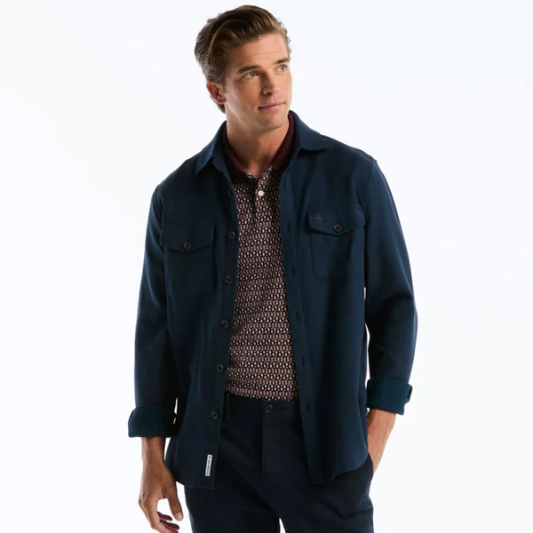 Model Wearing Original Penguin Jacquard Front Mid-Century Fairisle Polo Shirt in Port Royale - Front with jacket