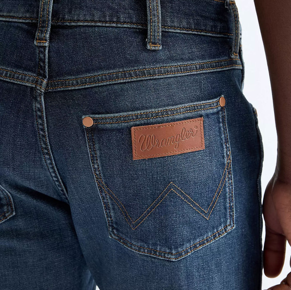 Model Wearing Wrangler Larston Slim Tapered Low Stretch Blue Denim Jeans in Moonlit - Back close up