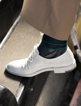 Close-up side view of Push med Aequi Flex ankle brace fitted on sock, highlighting supportive structure and wrap system.
