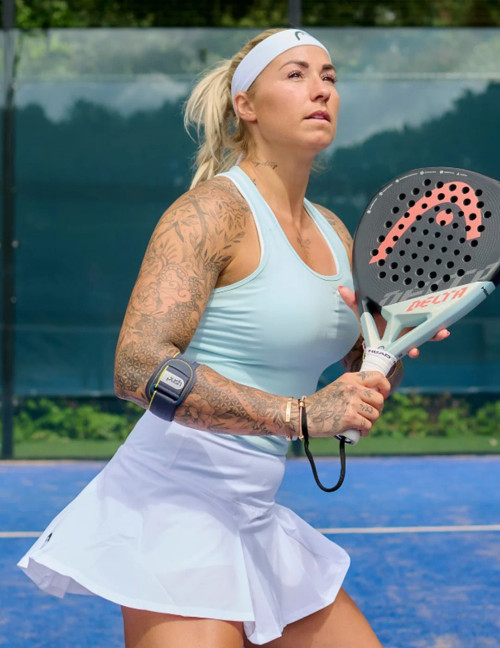 Athlete wearing the Push Sports Elbow Brace while playing tennis for targeted forearm support