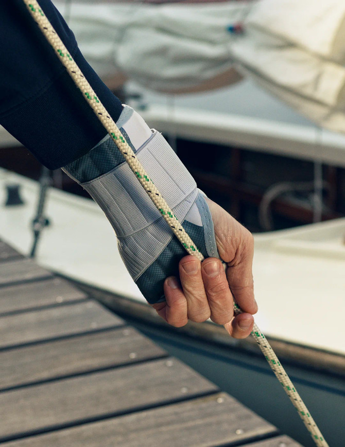 Wrist support used while gripping a rope, showing functional stability during light physical activity.