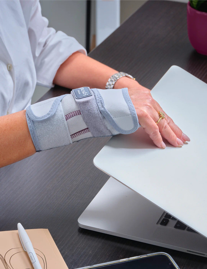 Person wearing Push med Wrist Brace Splint while working at a laptop demonstrating everyday wrist support.