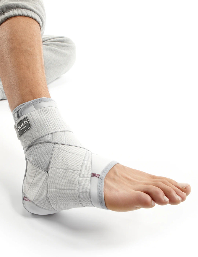 Side profile of Push med ankle brace showing anatomical fit and stabilising straps for controlled ankle support during movement.