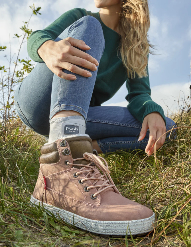 Push med ankle support worn outdoors during light activity, demonstrating stability and confidence while moving.