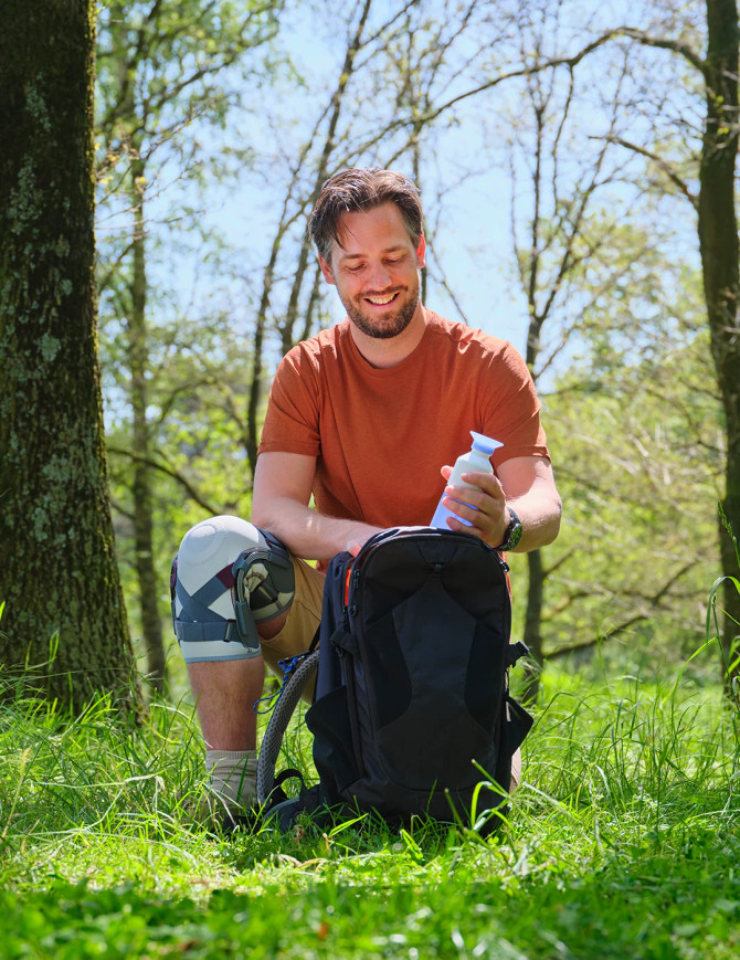 Outdoor lifestyle shot of user wearing Push med Knee Brace for knee support during recovery and daily movement.
