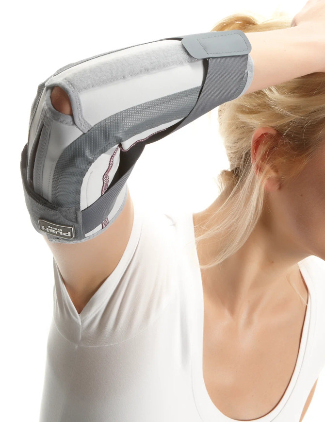 Close-up of Push med Elbow Brace showing anatomical fit, cross straps and breathable Sympress™ material.