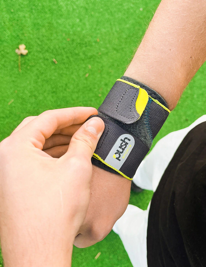 Push Sports Wrist Support worn outdoors during everyday activity to provide light compression and wrist stability