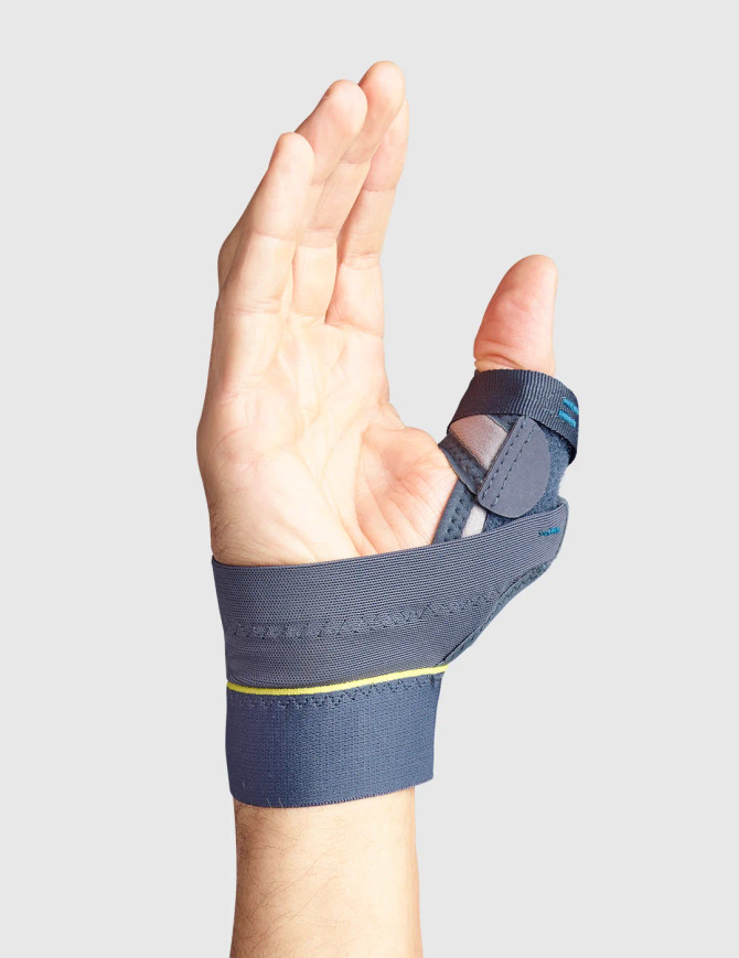 Low-profile thumb brace with protective cap and adjustable straps for everyday support