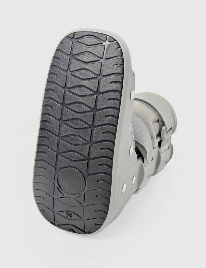 Sole view of paediatric walker boot showing textured outsole for traction and stability during walking.