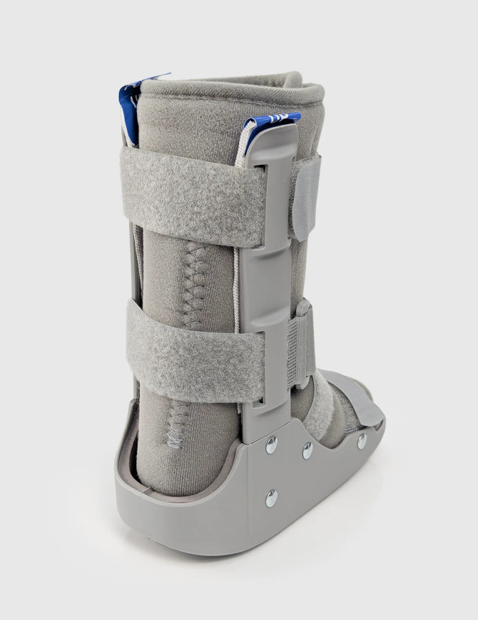 Rear view of paediatric walker boot showing rigid shell, padded lining, and adjustable straps for secure foot and ankle immobilisation.