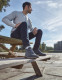 Lifestyle image of ankle brace providing support while seated outdoors, ideal for recovery from sprains and instability.