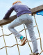Child climbing playground equipment while wearing Push ortho Ankle Brace Aequi Junior, showing stability during active movement and play.