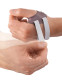 Close-up application image of Push CMC thumb brace being secured, highlighting easy adjustable fit and support.