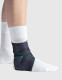 Push med Ankle Brace Aequi Flex worn on foot showing rigid shell support and diagonal stabilising strap for ankle instability.
