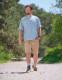 Full body lifestyle image of person walking outdoors while wearing Push med ankle brace for functional ankle support.
