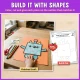 Build it with shapes: the finished monster craft next to its build mat with dashed shape outlines.