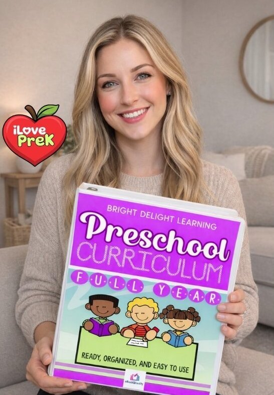 Teacher holding the iLovePreK Complete Preschool Curriculum binder
