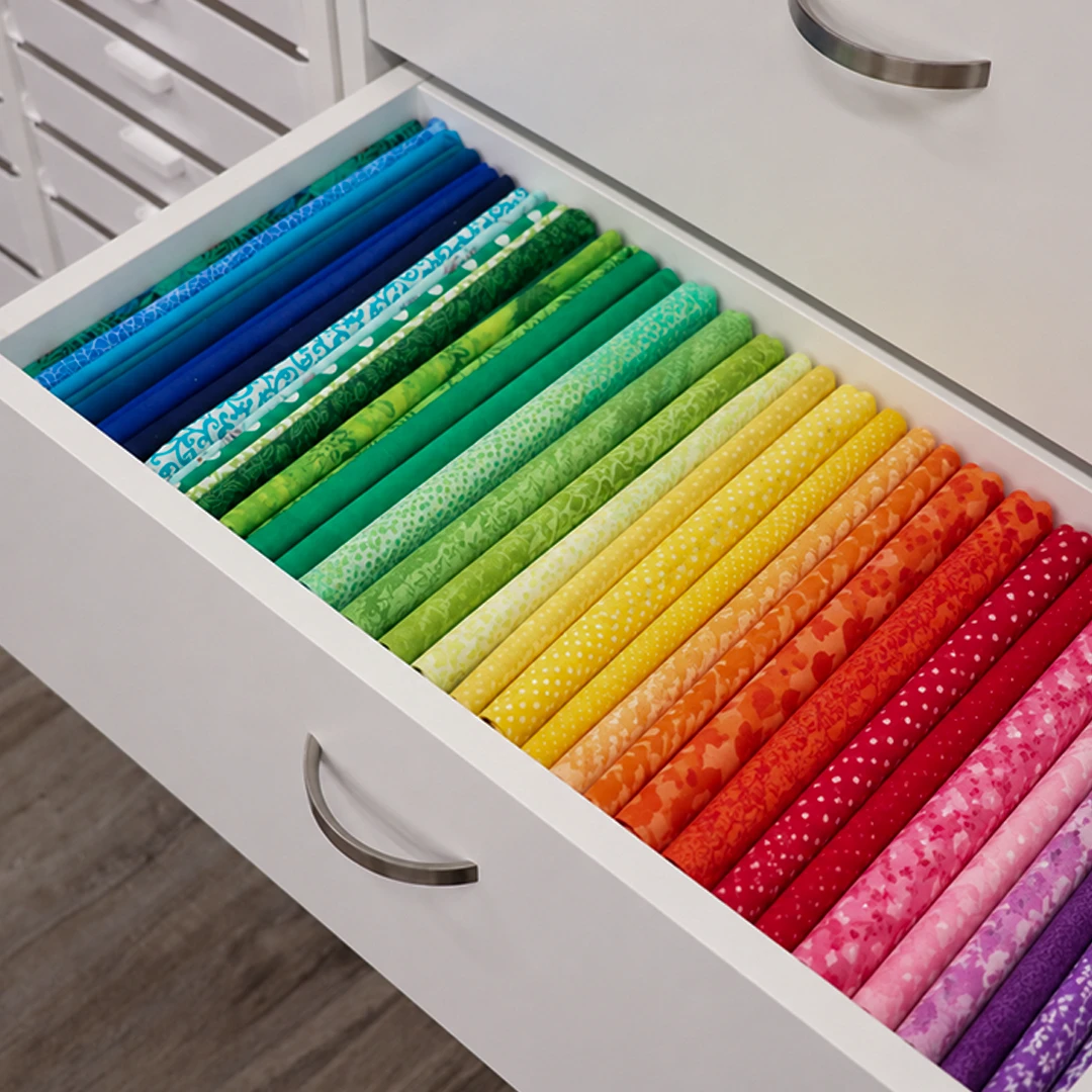 A drawer filled with rainbow-colored fabric wrapped on Fabric Wrap Boards