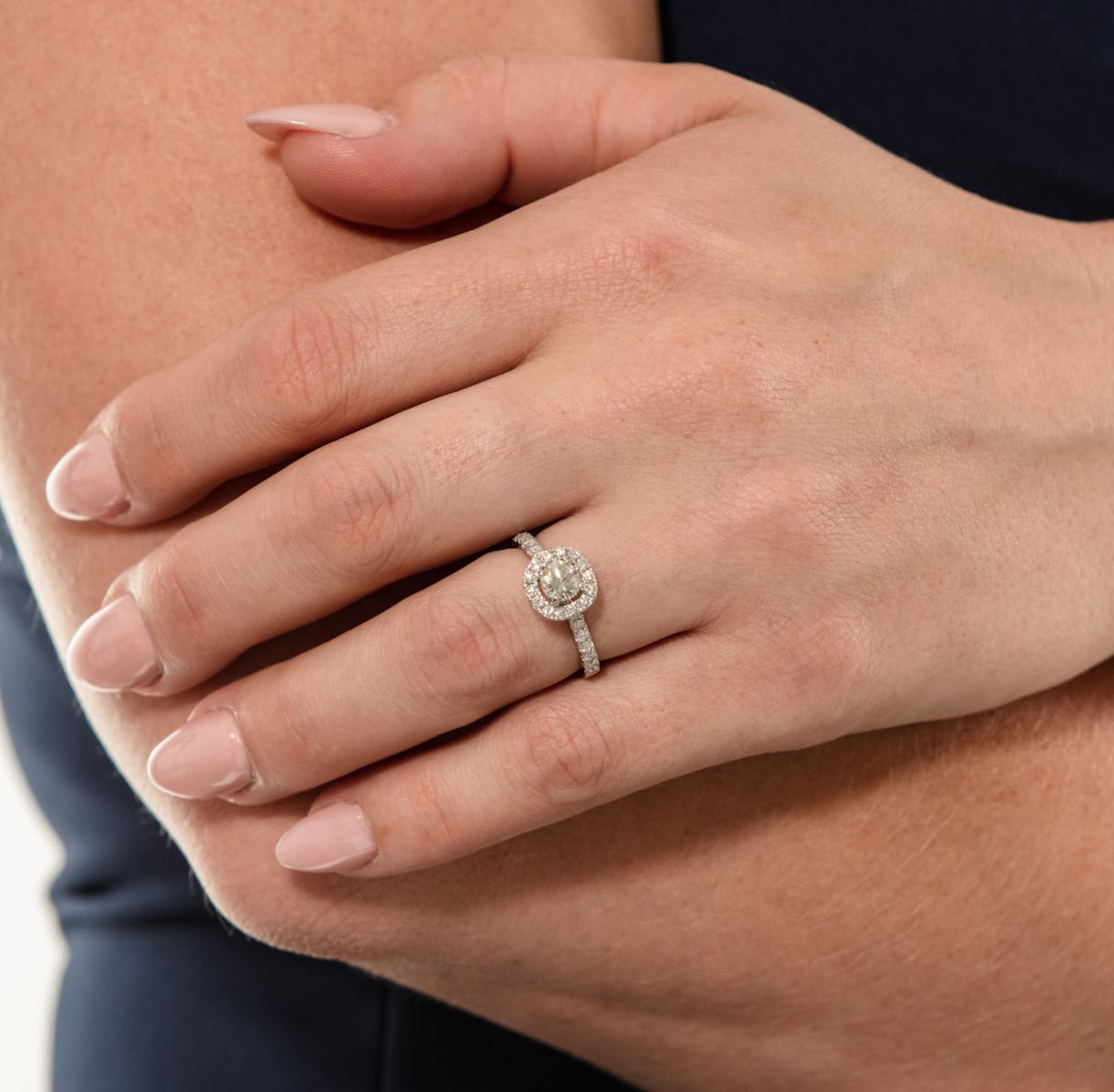 Model wearing platinum diamond halo ring.