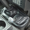Britpart Gear Lever Gaiter Black for Defender Puma, black leather gear shift gaiter in a vehicle interior.