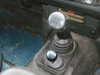 Britpart Alloy Gear Lever Knob Set LT77 for Defender, silver gear shift knob on a manual transmission in a vehicle interior. Britpart Alloy Gear Lever Knob Set LT77 for Defender, silver gear shift knob on a manual transmission in a vehicle interior.