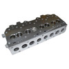 Direct Replacement Cylinder Head Complete for 300Tdi Engines, image of an engine cylinder head with multiple drilled holes for valves and mounting points.
