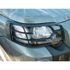 Direct Replacement Front Lamp Guard Pair for Freelander 1, black metal front headlamp guard on a grey vehicle with water droplets.