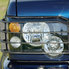 Britpart Front Lamp Guard Pair - STC53193 for Discovery 2, black metal front lamp protection guard fitted on vehicle headlight.