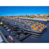ARB 4X4 Accessories ARB TRED Pro 4x4 Recovery Tracks Grey/Orange, rugged recovery tracks with orange accents on a vehicle's roof rack against a clear blue sky and desert landscape.