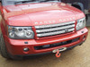 Britpart Discrete Recovery Winch Mount for Range Rover Sport, red vehicle front view showing the winch mount mounted on the front bumper with a red hook. Britpart Discrete Recovery Winch Mount for Range Rover Sport, red vehicle front view showing the winch mount mounted on the front bumper with a red hook.