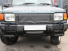 Britpart Radiator Muff Grill Cover 300TDi for Discovery 1, front view of a Land Rover Discovery 1 with a black radiator grill cover installed.