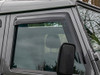 Britpart Front Window Wind Deflectors DA6078 - Reduce Noise & Buffeting for Defender, close-up image showing the wind deflectors installed on the front windows of a vehicle.