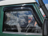 Britpart Front Window Wind Deflectors DA6078, installed on a vehicle's front window, designed to reduce noise and buffeting for Defender models.